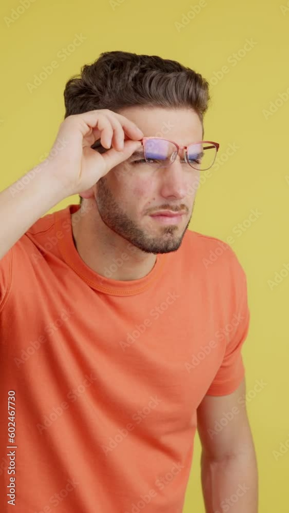 Caucasian man taking off her glasses to see far away