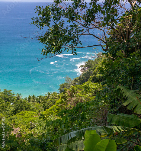 looking down on Freedom Beach Phuket Thailand. Magnificent colours in the sky and turquoise blue waters and white sandy beach through the lush green colours of the rainforest 