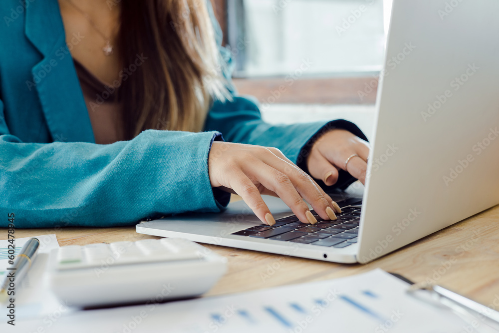 Business woman working in office with documents and laptop. Business concept Business woman working in office with documents and laptop. Business concept