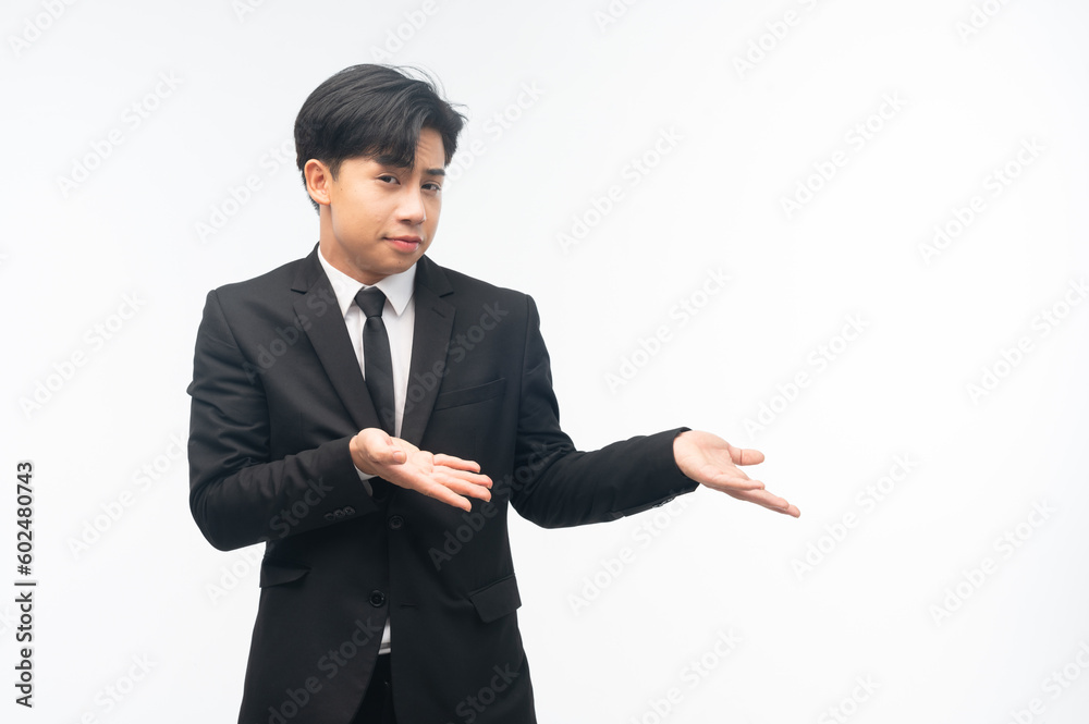 handsome businessman holding hand presenting product empty copy space standing over isolated white background. handsome businessman holding hand presenting product empty copy space standing over isolated white background.