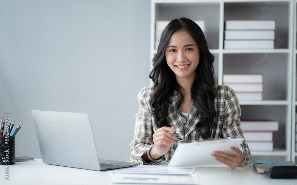 Portrait of young beautiful businesswoman working in the office room with laptop computer. Portrait of young beautiful businesswoman working in the office room with laptop computer.