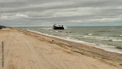 The Coast Guard hovercraft moves quickly along the beach. Patrolling the coastline
