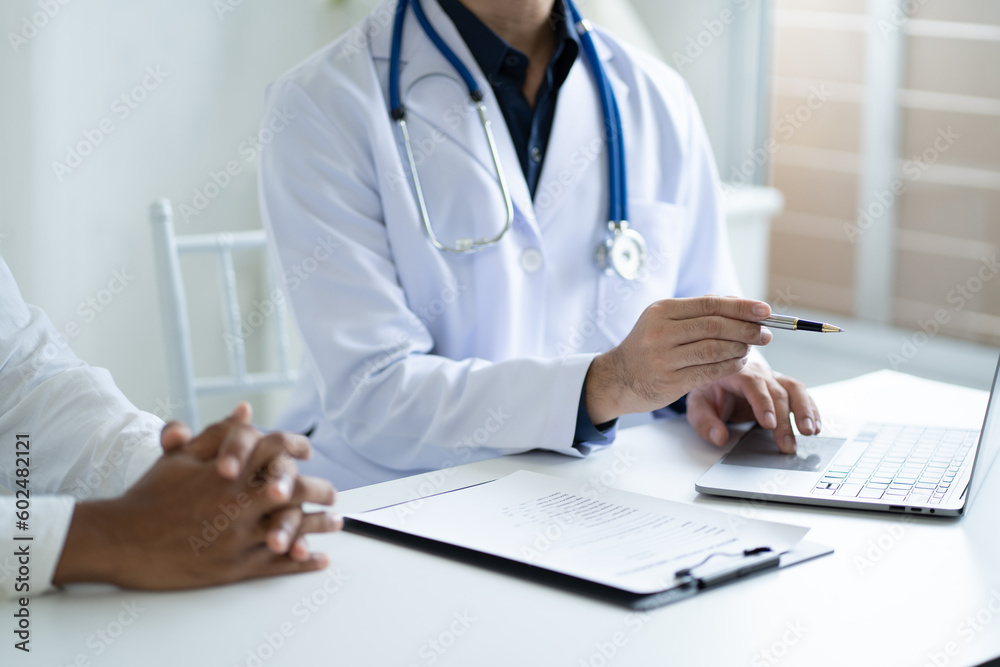 Close up view of professional physician consulting with male patient, talking to male client at medical checkup visit Close up view of professional physician consulting with male patient, talking to male client at medical checkup visit