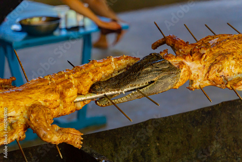Crocodile on a spit grill. A bay on an island near Nha Trang in Vietnam. Tourist destination.