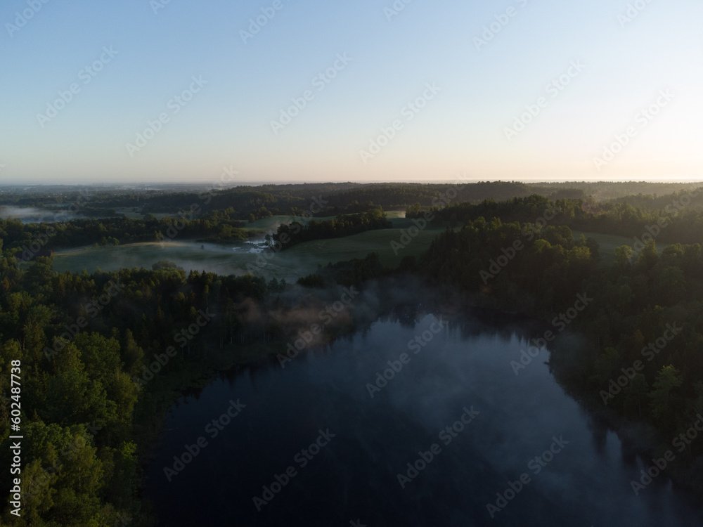 Majestic Morning: A Drone's Eye View of a Misty Lake in the Woods at Sunrise in Northern Europe