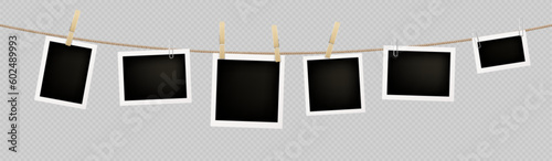 Realistic set of instant photos hanging on rope attached with clothespins and paperclips. Vector illustration of square blank paper photographs in white frames isolated on transparent background