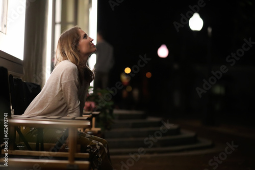 Girl sitting in a cafe at night
