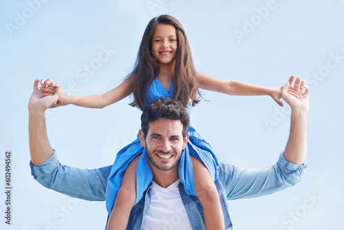 Blue sky, piggyback and happy family portrait of father, child or people having fun, playing outdoor game and bonding. Shoulder ride, summer sunshine and relax kid and dad smile for peace and freedom