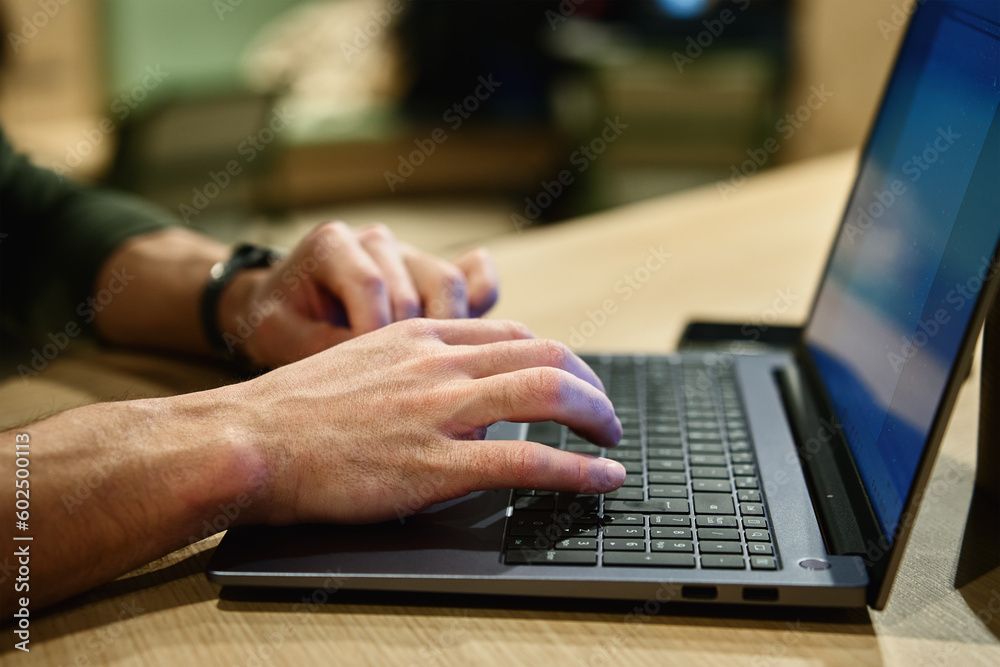 Male hands typing on laptop keyboard, close up. Man using laptop in office. Online work Male hands typing on laptop keyboard, close up. Man using laptop in office. Online work