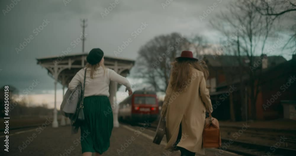 Two friends are hurrying to catch a departing train