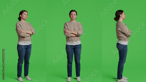 Caucasian woman standing over full body green screen backdrop  posing in front of camera. Girl model feeling confident and joyful sitting on greenscreen background in studio  casual look.