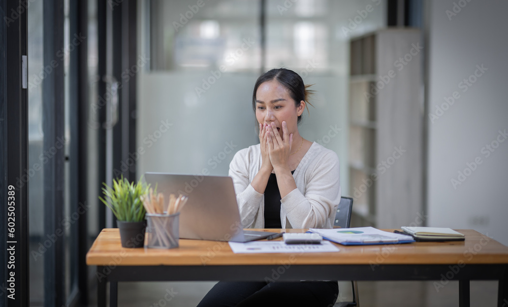 Happy excited successful business asian woman triumphing in office, Portrait of a cheerful Asian businesswoman sitting at the table in office,
Happy excited successful business asian woman triumphing in office, Portrait of a cheerful Asian businesswoman sitting at the table in office,