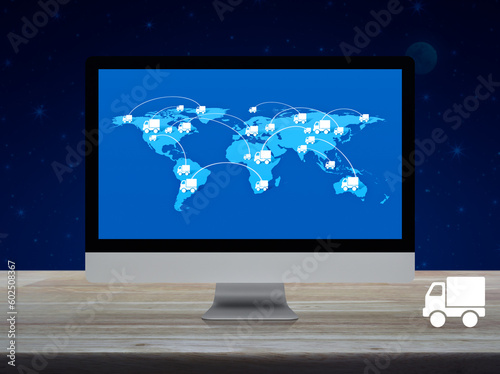 Delivery truck icon with connection line and world map on computer screen on wooden table over fantasy night sky, Business transportation online service, Elements of this image furnished by NASA