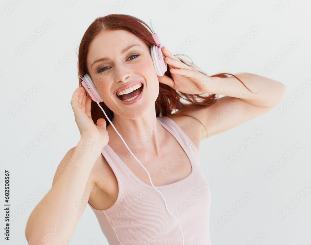 Naklejka premium Woman, headphones and studio portrait with smile for music, streaming subscription or podcast by background. Isolated girl, student or model with happiness for audio, sound and internet radio by wall