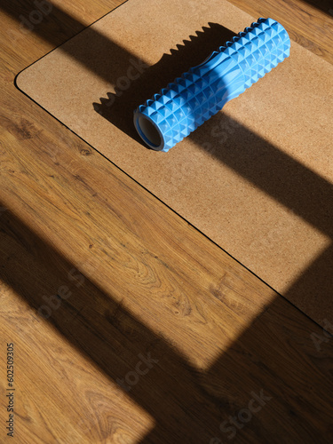Image of corkwood yoga mat on the floor of a bright sunny studio with copyspace