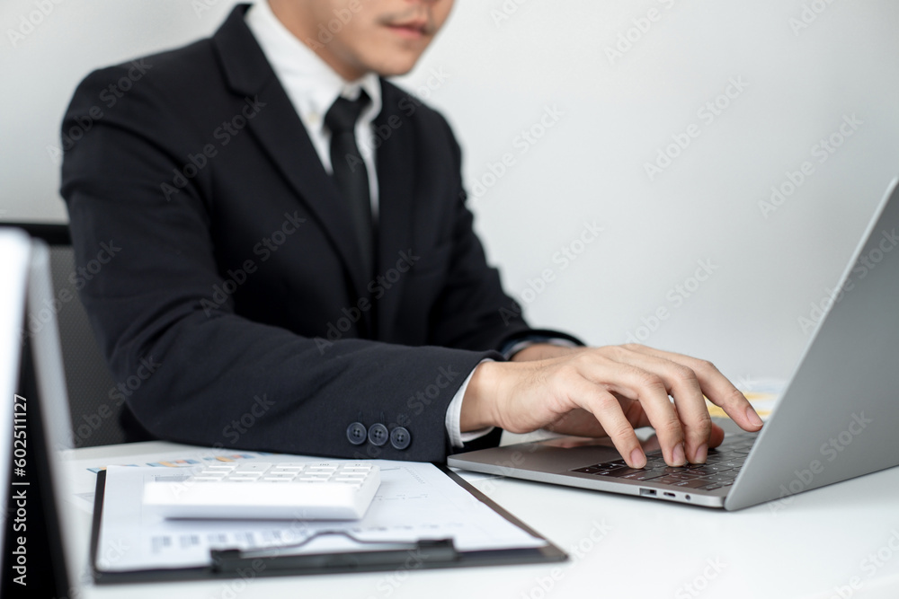 Smart businessman’s sitting in the office room and using computer to plan about marketing investment for his business. Smart businessman’s sitting in the office room and using computer to plan about marketing investment for his business.
