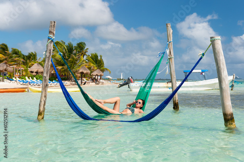sexy woman relax at summer beach in hammock. photo of woman relax at summer beach.