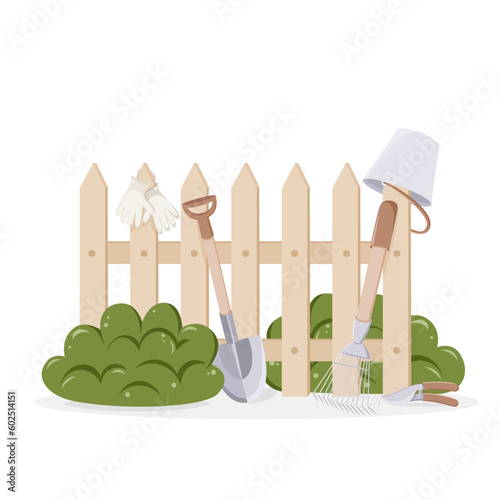 Garden tools near fence in countryside. Shovel, bucket, secateurs, rake. Agriculture, gardening and harvesting concept.  Cute isolated vector illustration in cartoon style