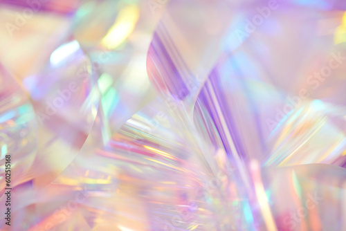 Blurred closeup of ethereal pastel neon pink, purple, lavender, orange, yellow holographic metallic foil background. Abstract modern surreal futuristic disco, rave, techno, festive dreamlike backdrop