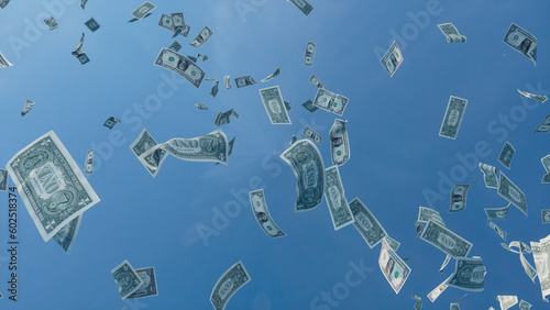 Money falling from the Sky. One Dollar Bills against Blue Sky backdrop. Finance concept. photo