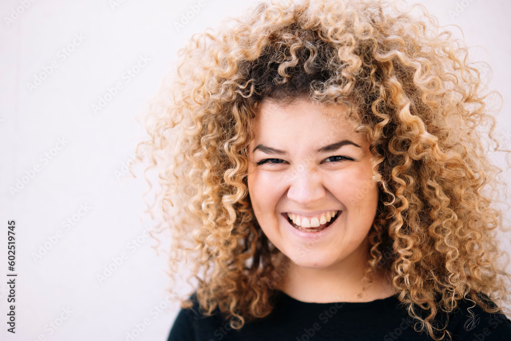 Happy young woman with curly hair against white background Happy young woman with curly hair against white background