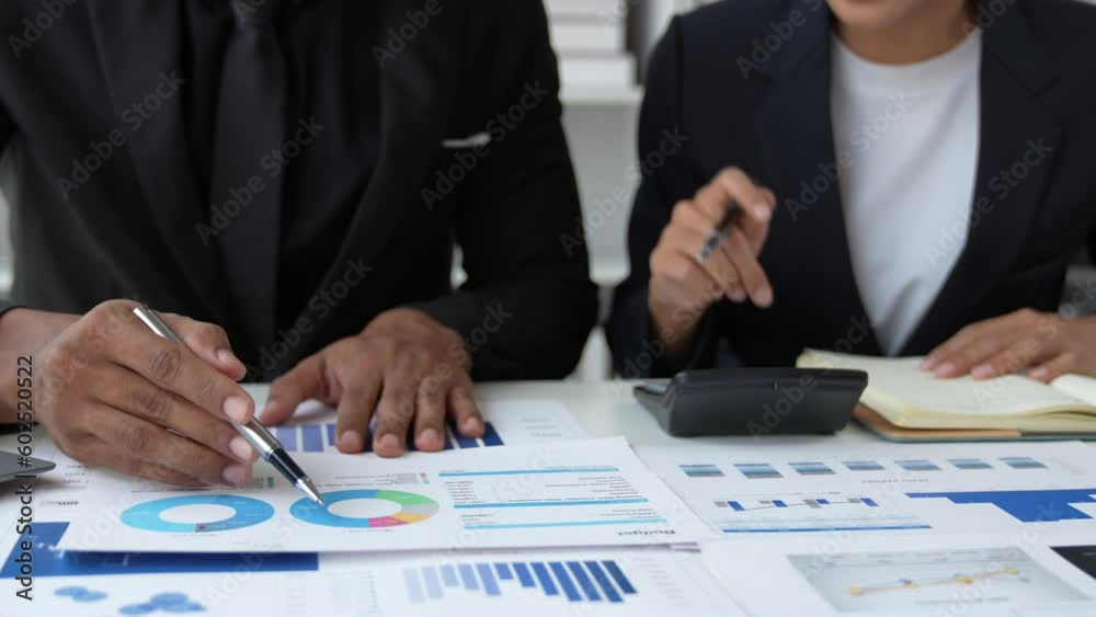 Financial analyst analyzes business finance reports on laptop and graph documents during corporate meeting discussions showing successful teamwork, business meeting ideas, marketing. Financial analyst analyzes business finance reports on laptop and graph documents during corporate meeting discussions showing successful teamwork, business meeting ideas, marketing.