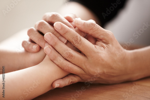 Support, love and spiritual with people holding hands in comfort, care or to console each other. Trust, empathy or healing with friends praying together during depression, anxiety or the pain of loss © Alexandra W/peopleimages.com