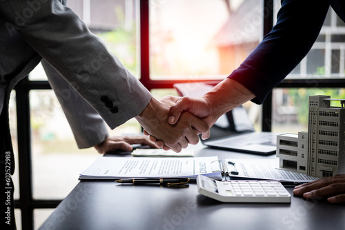 Successful handshake and agreement Real estate agent and client celebrating contracts completed after signing on home insurance and investment loans. house sale ideas photo