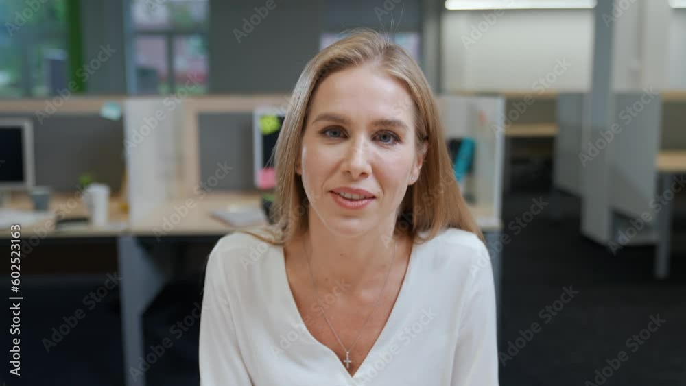 Portrait of a cheerful woman designer against the background of international office space, young woman communicates by video call, talks looking at the camera, template. Portrait of a cheerful woman designer against the background of international office space, young woman communicates by video call, talks looking at the camera, template.