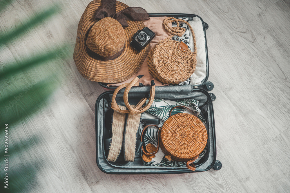 Vacation and travel concept. Suitcase, hat, bag and sunglasses on wooden floor Vacation and travel concept. Suitcase, hat, bag and sunglasses on wooden floor