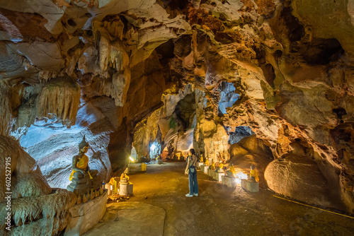 The woman is sightseeing a cave at Wat Khao Tham Ma Rong, Bang Saphan, Prachuap Khiri Khan, Thailand