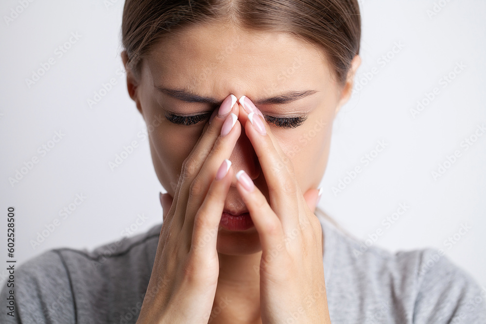 Feeling strong headache massaging temples exhausted from overwork, fatigued overwhelmed lady. Feeling strong headache massaging temples exhausted from overwork, fatigued overwhelmed lady.