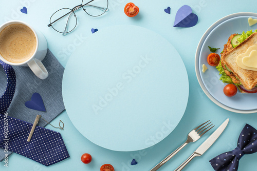 Make Dad's day with a homemade breakfast. Top view of a sandwich with veggies, cutlery, coffee, napkin, necktie, glasses, bow-tie, men's accessories, on pastel blue background with circle for text