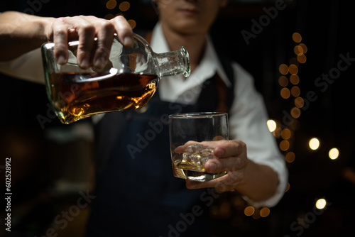 Barman pouring whiskey whiskey glass beautiful night