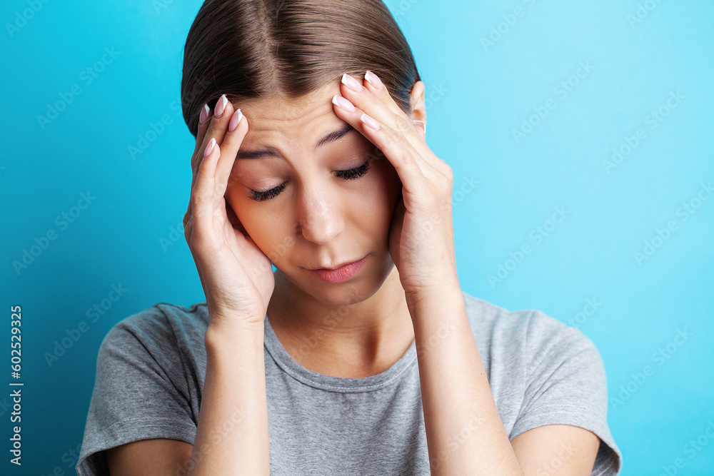 Feeling strong headache massaging temples exhausted from overwork, fatigued overwhelmed lady. Feeling strong headache massaging temples exhausted from overwork, fatigued overwhelmed lady.