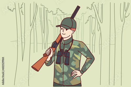 Man hunter with double-barreled gun stands in forest with binoculars to track down wild animal and search for prey. Gamekeeper guy protects animals from national park from hunter or poacher