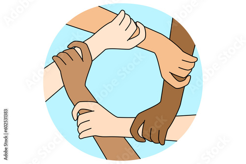 Multiracial people join hands in circle