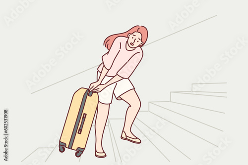 Woman tourist pulls travel suitcase up uncomfortable stairs at train station or airport