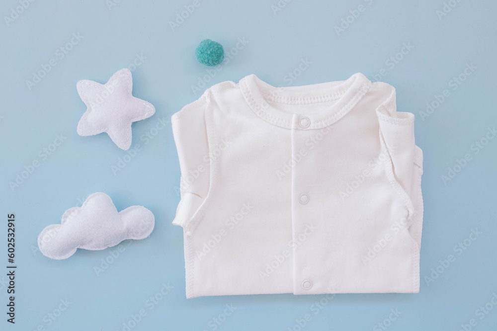 Bodysuit for a newborn on a blue background. Waiting for the boy. Clothes for newborns Bodysuit for a newborn on a blue background. Waiting for the boy. Clothes for newborns
