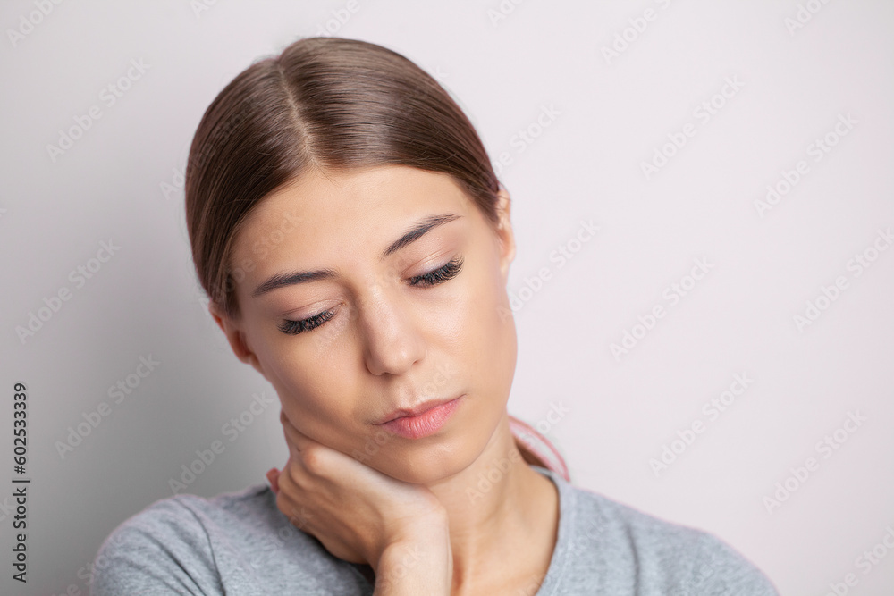 Young woman feeling exhausted and suffering from neck pain, health concept. Young woman feeling exhausted and suffering from neck pain, health concept.