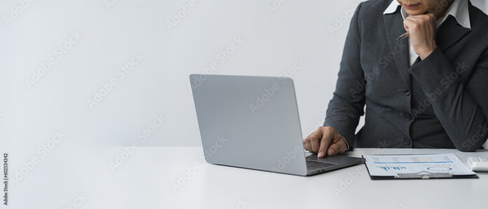 copy space, banner, panorama business woman working on the table sits analyzing graph data Document charts use a calculator to analyze business growth plans. Finance, Marketing and Accounting Concept copy space, banner, panorama business woman working on the table sits analyzing graph data Document charts use a calculator to analyze business growth plans. Finance, Marketing and Accounting Concept