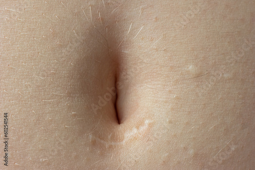 Young woman's belly button. Macro close up shot, unrecognizable person photo