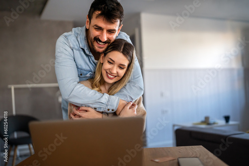Young happy couple having video call online, conversation with relatives, communicating with friends
