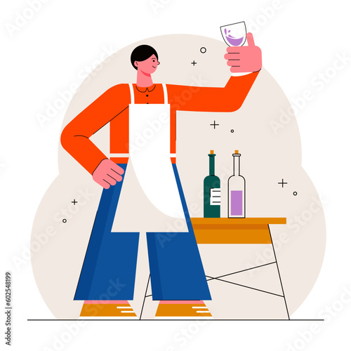 Taster standing in factory near table with wine bottles, holding glass of wine and checking color