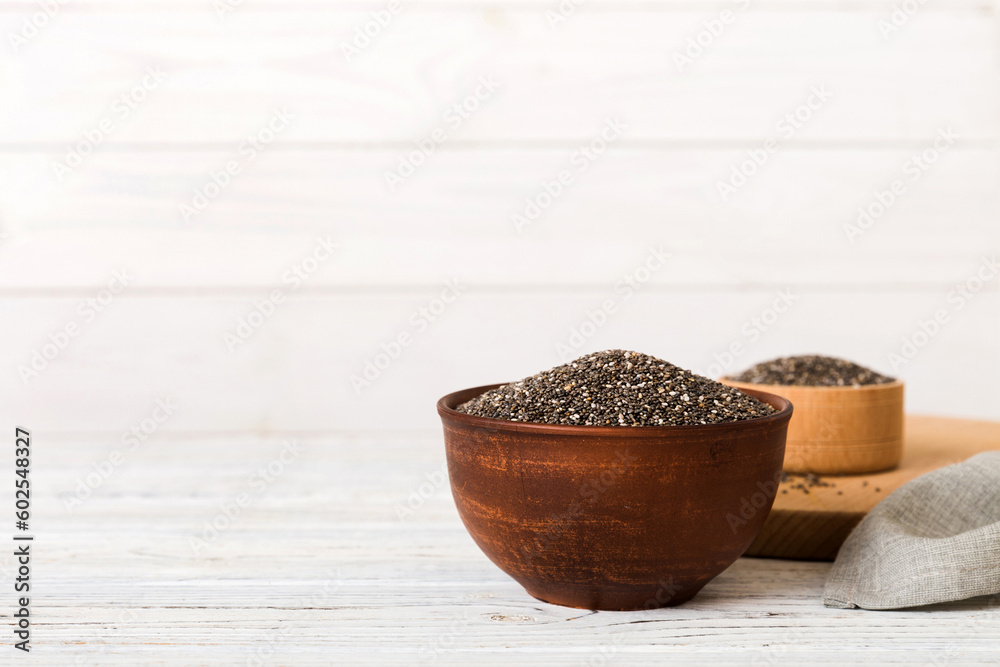 Chia seeds in bowl on colored background. Healthy Salvia hispanica in small bowl. Healthy superfood