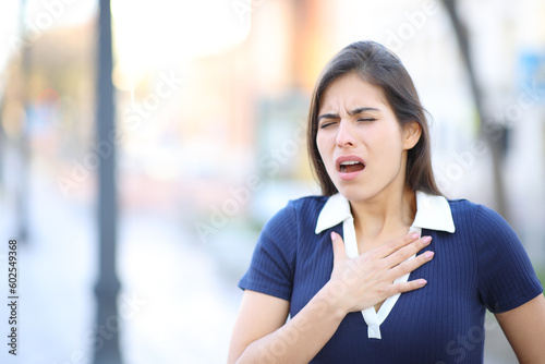 Stressed woman choking in the street photo