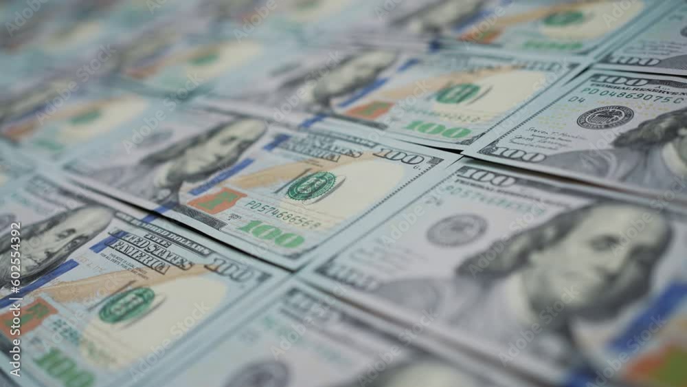 Dolly shot of cash money. American hundred dollars lying in row, focus on portrait of Benjamin Franklin. Banknotes symbolizing success. Concept of finance and money payment Dolly shot of cash money. American hundred dollars lying in row, focus on portrait of Benjamin Franklin. Banknotes symbolizing success. Concept of finance and money payment