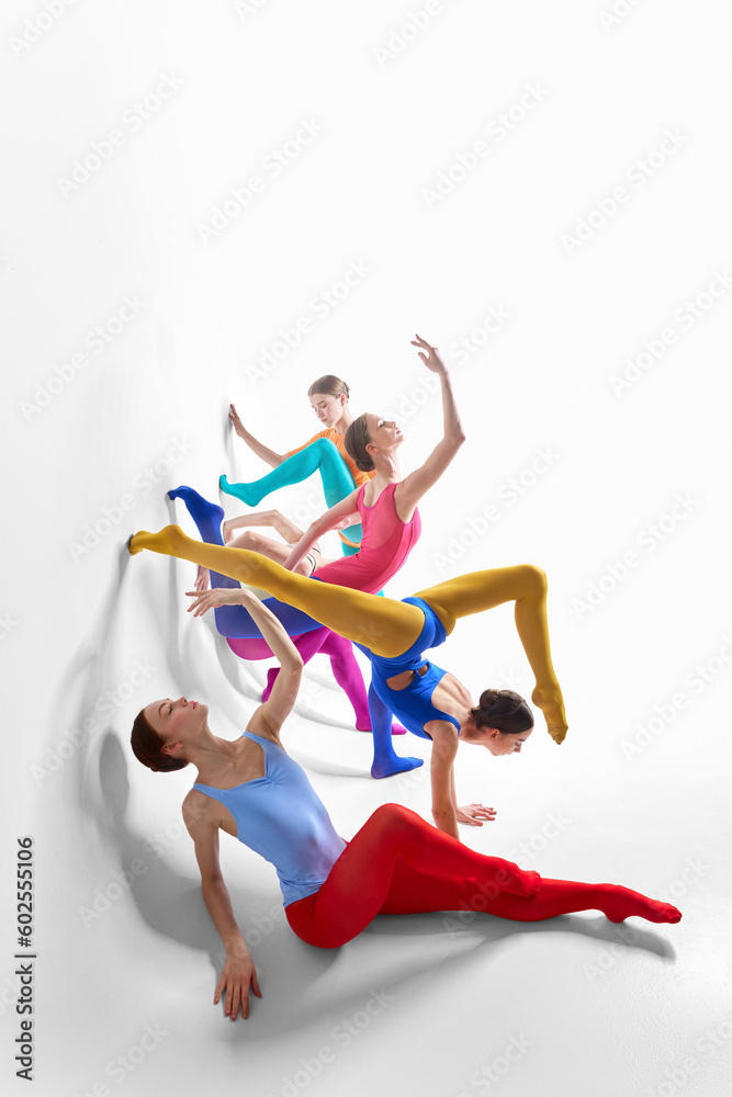 Expression. Young girls, ballet dancer in bright tights and bodysuits dancing against grey studio background. Concept of beauty, creativity, classic dance style, elegance, contemporary art