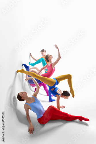 Expression. Young girls, ballet dancer in bright tights and bodysuits dancing against grey studio background. Concept of beauty, creativity, classic dance style, elegance, contemporary art