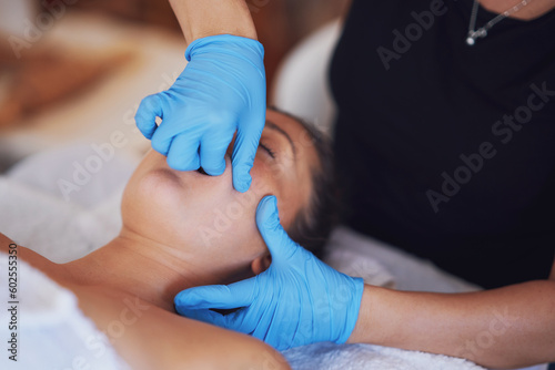Woman having mouth massage in blue gloves